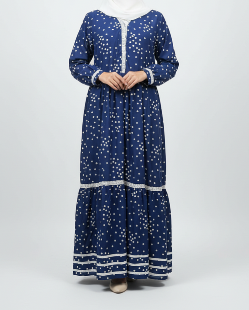 Woman wearing a blue patterned dress with a white headscarf on a white background